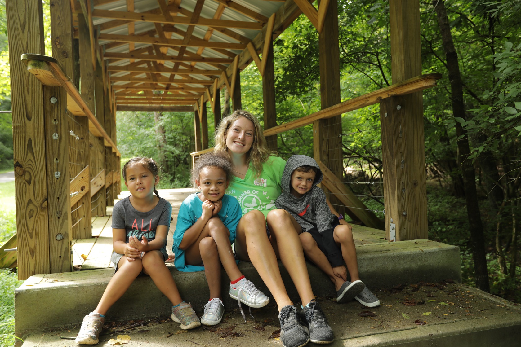 YMCA Louisville staff poses with children outdoors YMCA Louisville staff poses with children outdoors