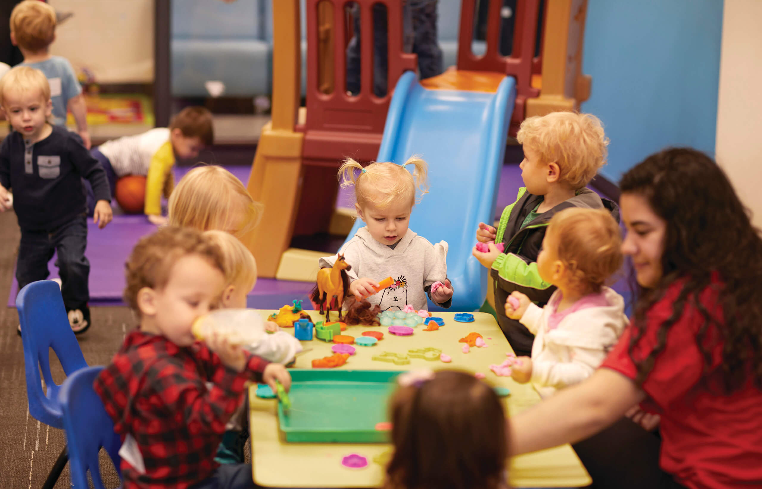 YMCA staff crafting with kids during child care program YMCA staff crafting with kids during child care program