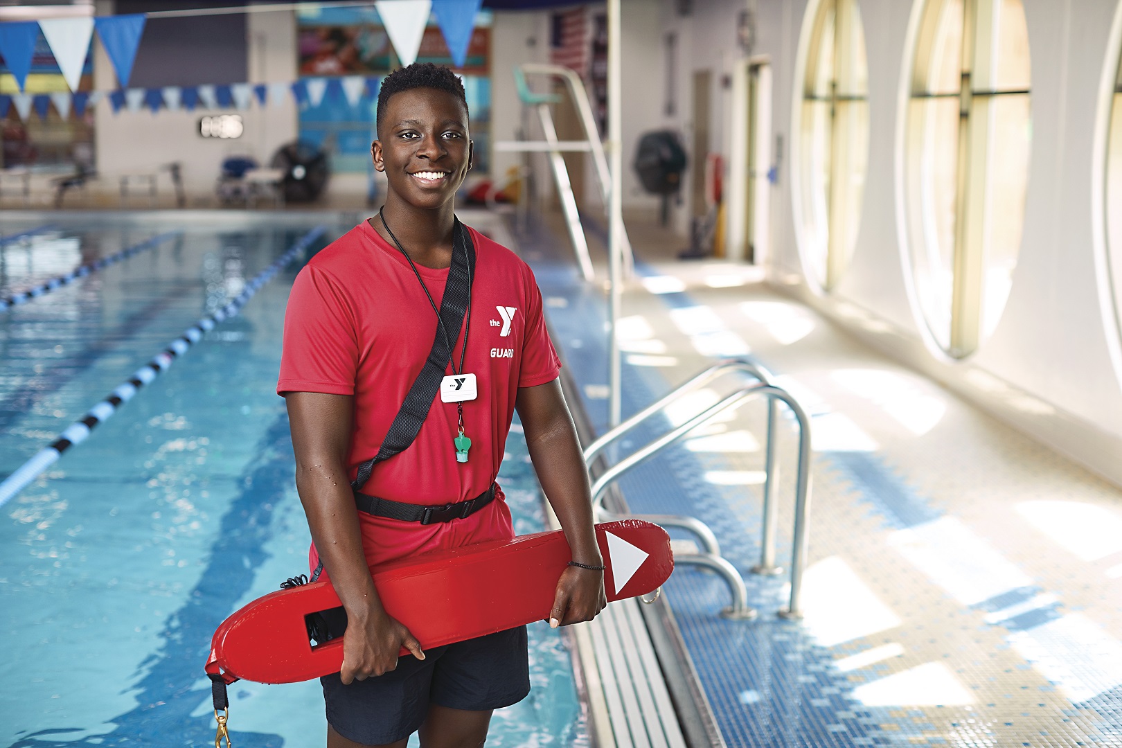 Lifeguard smiling at YMCA swimming pool Lifeguard smiling at YMCA swimming pool