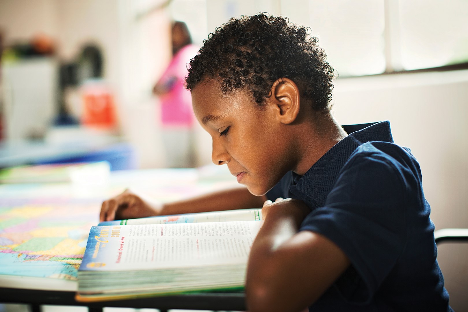 Child reading book at YMCA programs for black youth Child reading book at YMCA programs for black youth