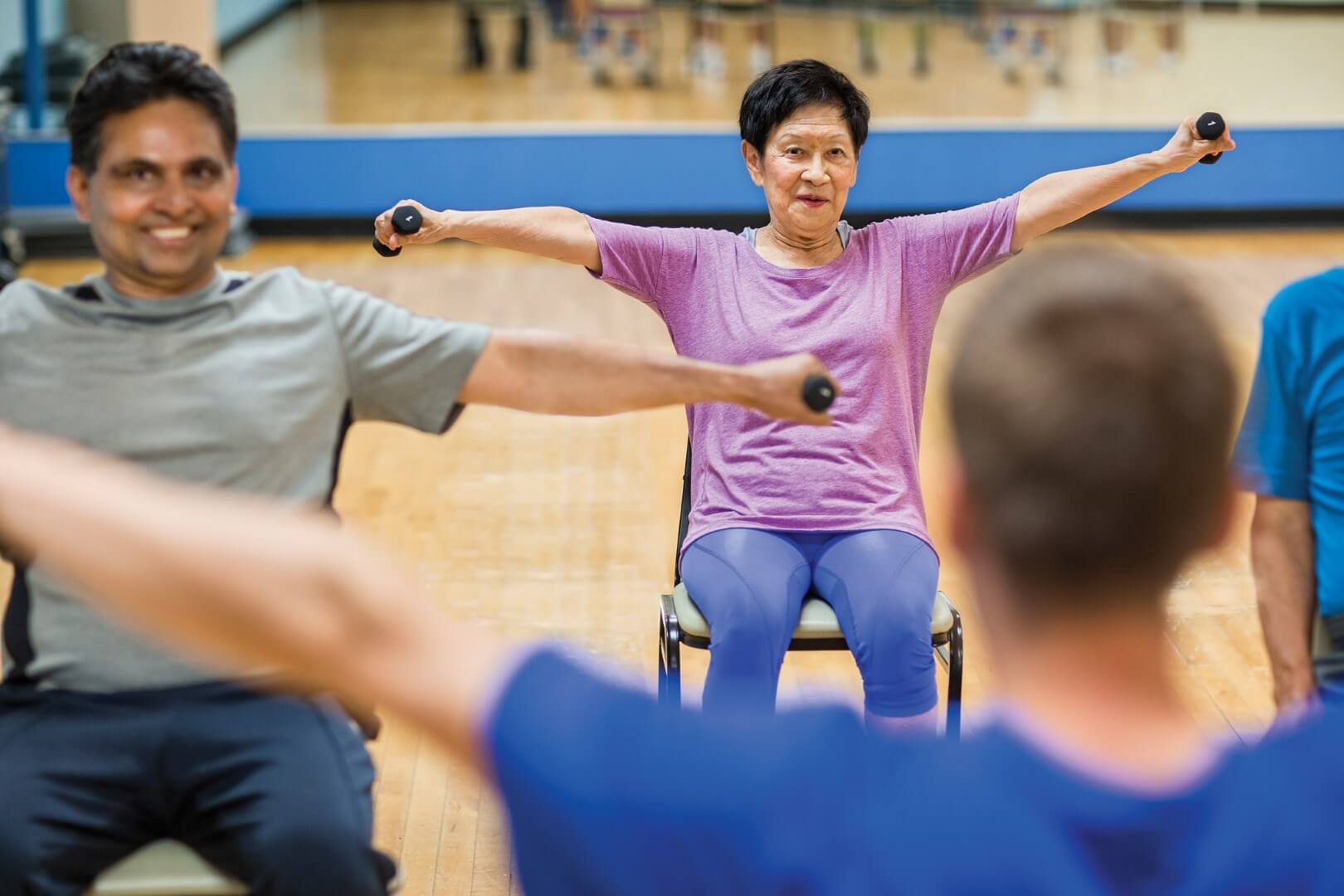 Adults lifting dumbbells at YMCA Louisville forever young fitness class Adults lifting dumbbells at YMCA Louisville forever young fitness class