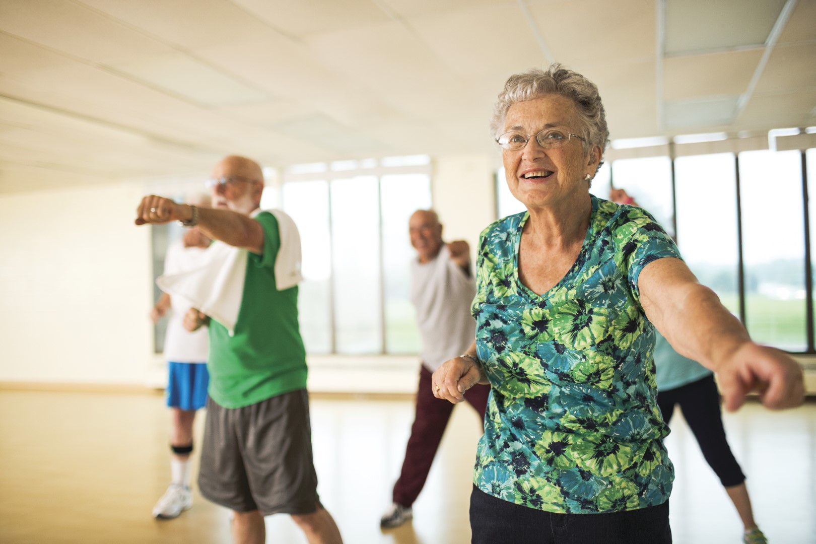 Older adults stretching at group dance class at YMCA Louisville Older adults stretching at group dance class at YMCA Louisville