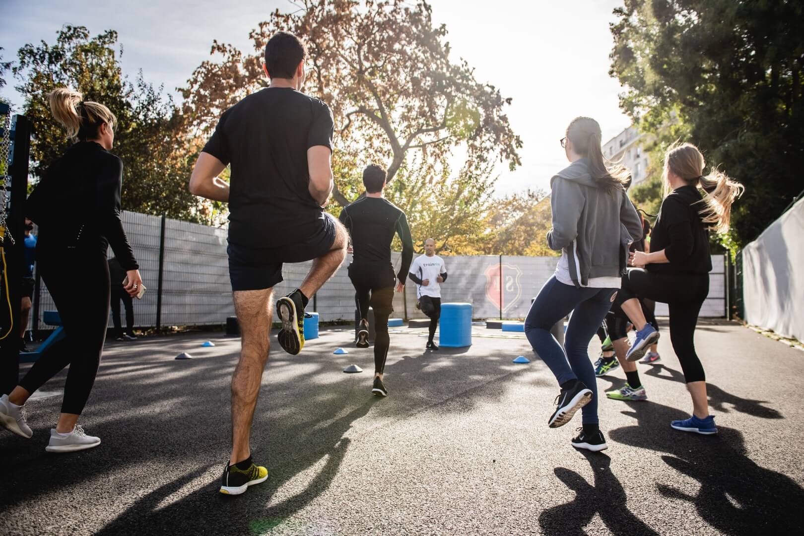 Adults jogging in place in group cardio class Adults jogging in place in group cardio class