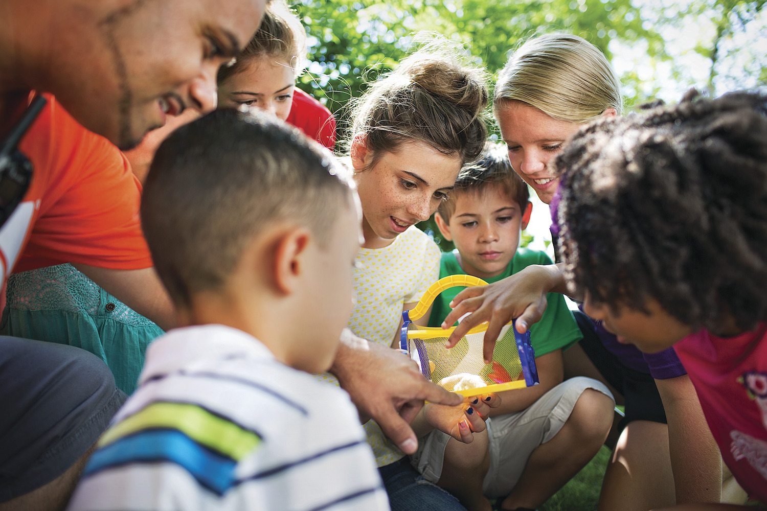Children surrounding YMCA camp counselor at YMCA Louisville Summer Day Camps Children surrounding YMCA camp counselor at YMCA Louisville Summer Day Camps