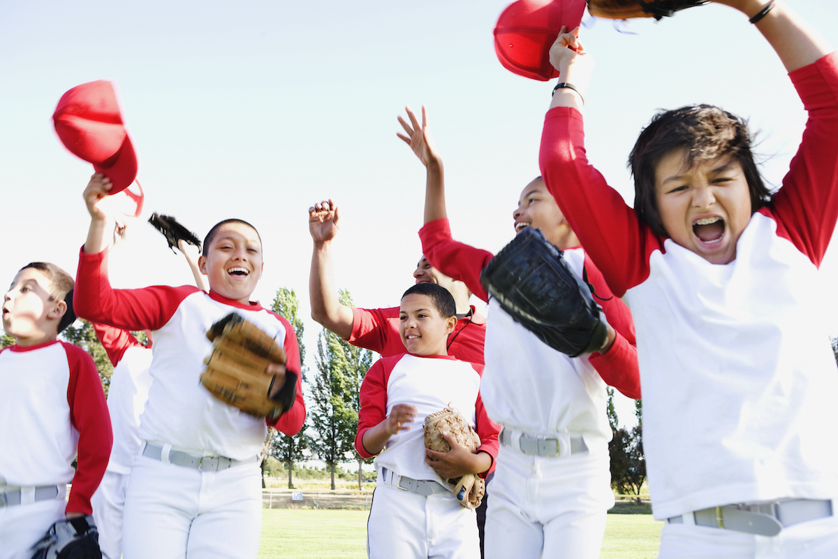 Kids cheering during youth baseball league game Kids cheering during youth baseball league game