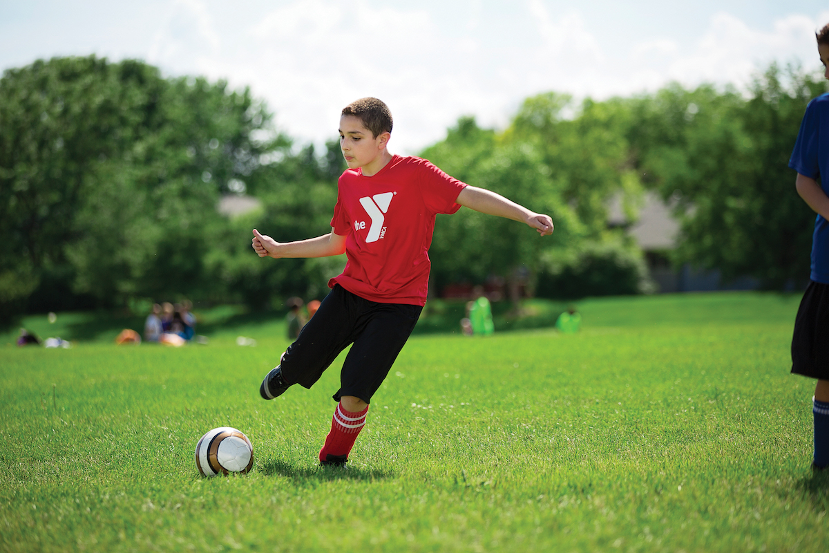 Kids playing in youth soccer league game Kids playing in youth soccer league game