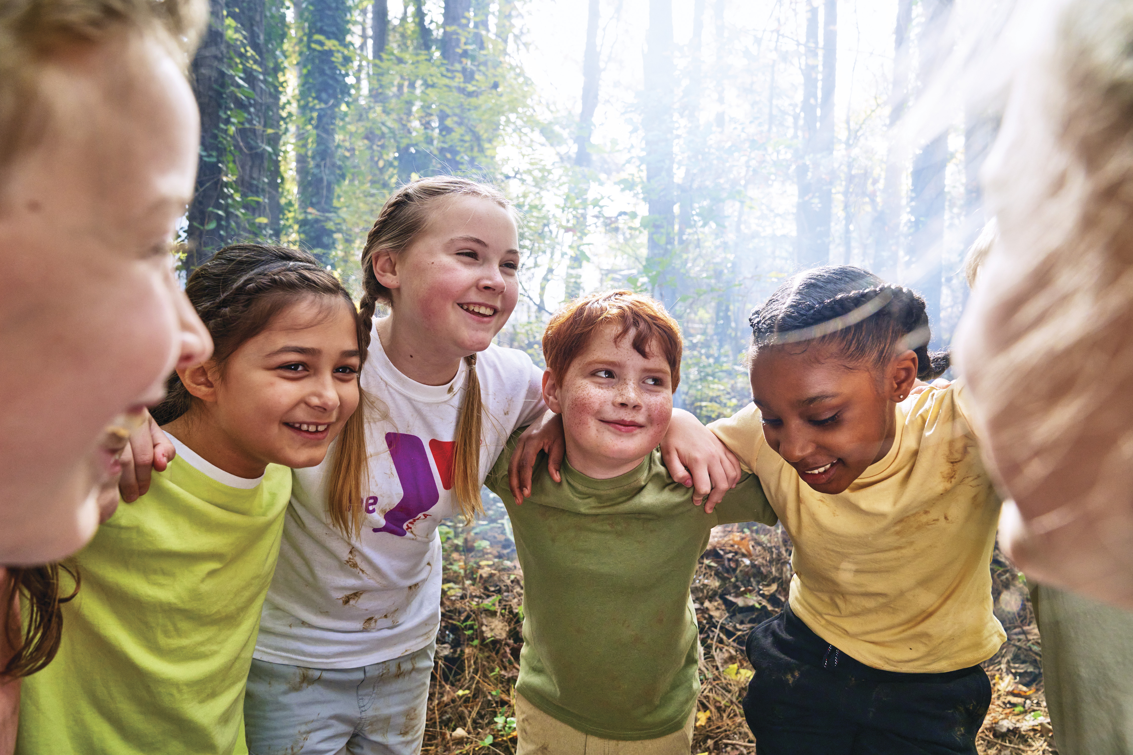Group of kids outdoors in a circle smiling Group of kids outdoors in a circle smiling