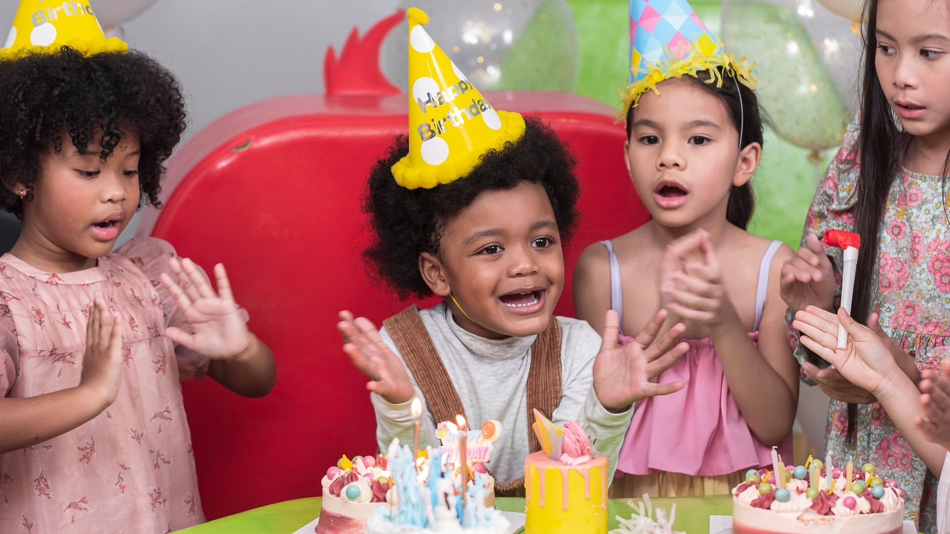 Group of kids in party hats clapping hands Group of kids in party hats clapping hands