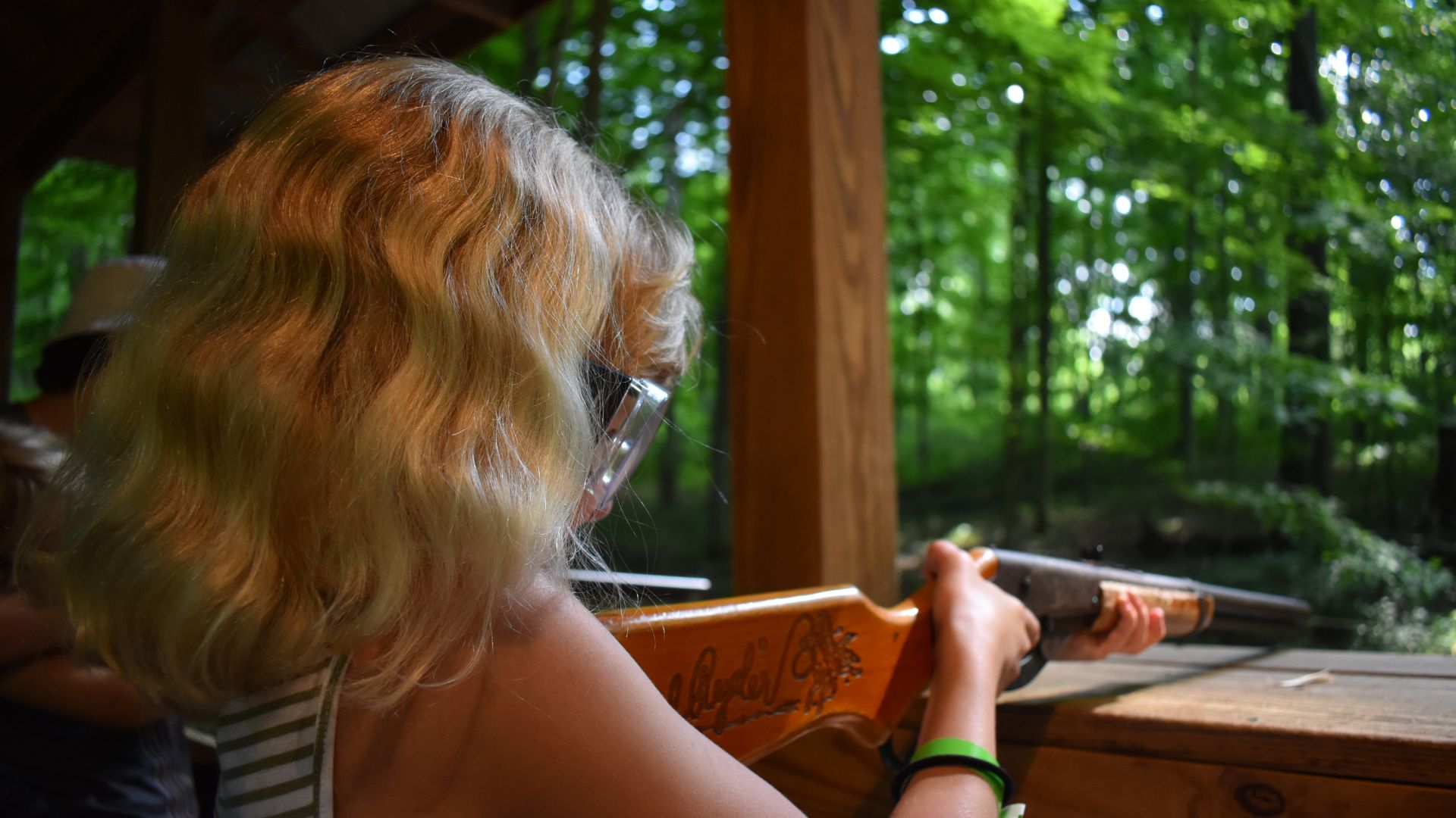 Camper in safety glasses preparing to shoot BB gun Camper in safety glasses preparing to shoot BB gun