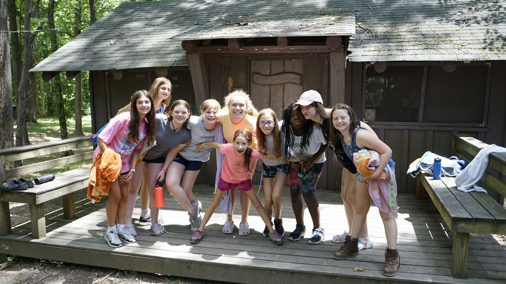 Group of campers standing together outside of their cabin at YMCA Camp Piomingo Group of campers standing together outside of their cabin at YMCA Camp Piomingo
