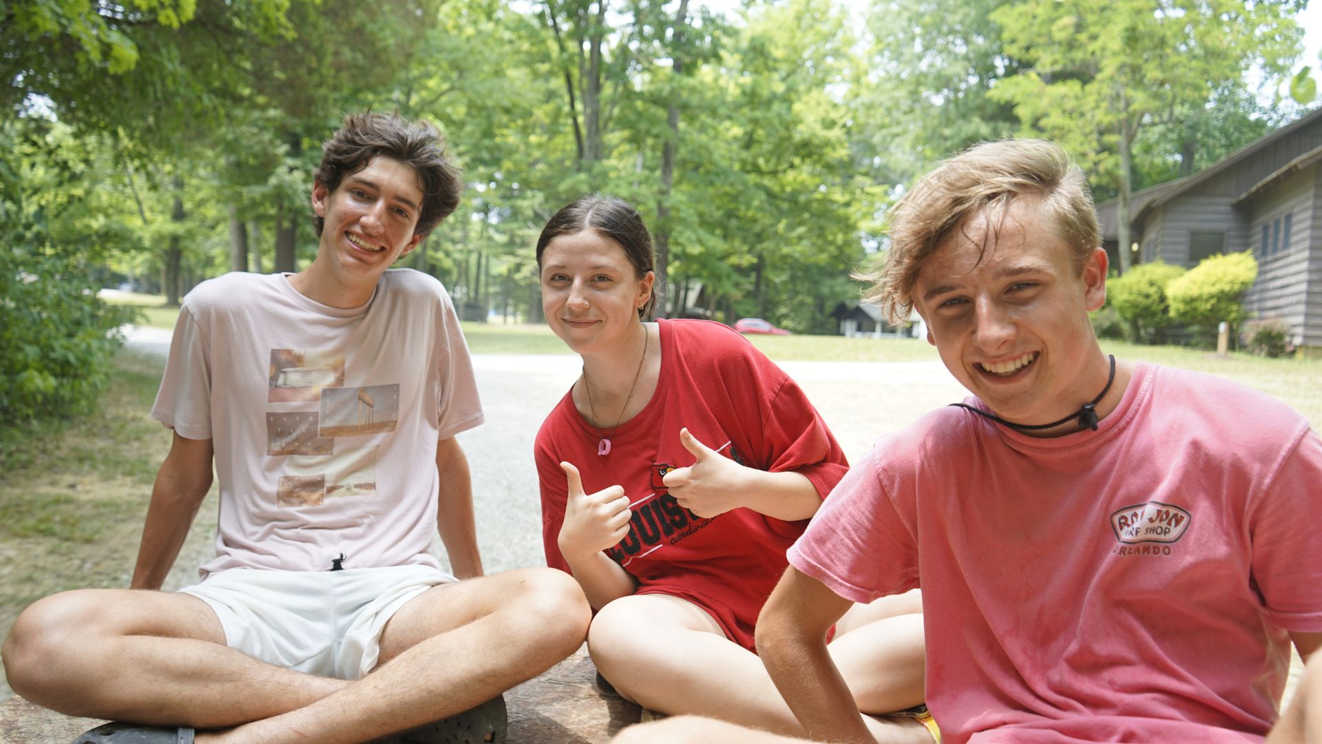 3 campers sitting outside together at YMCA Camp Piomingo 3 campers sitting outside together at YMCA Camp Piomingo