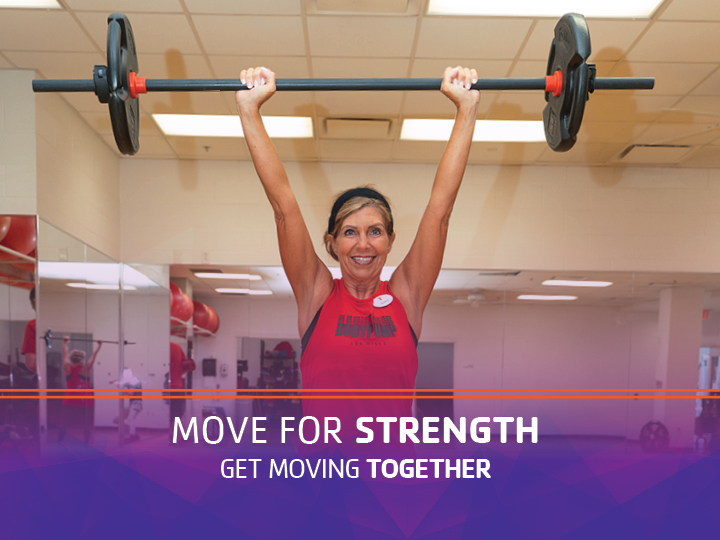 Woman in a strength group fitness class Woman in a strength group fitness class
