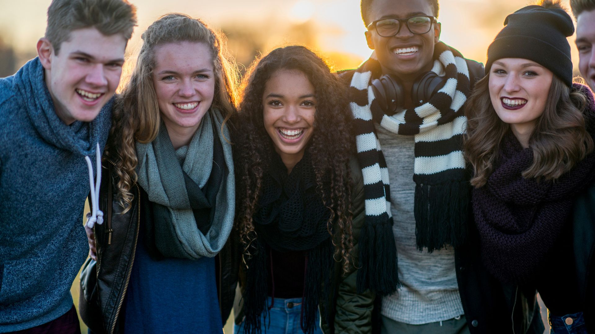 Group of teens standing outside together in the fall Group of teens standing outside together in the fall