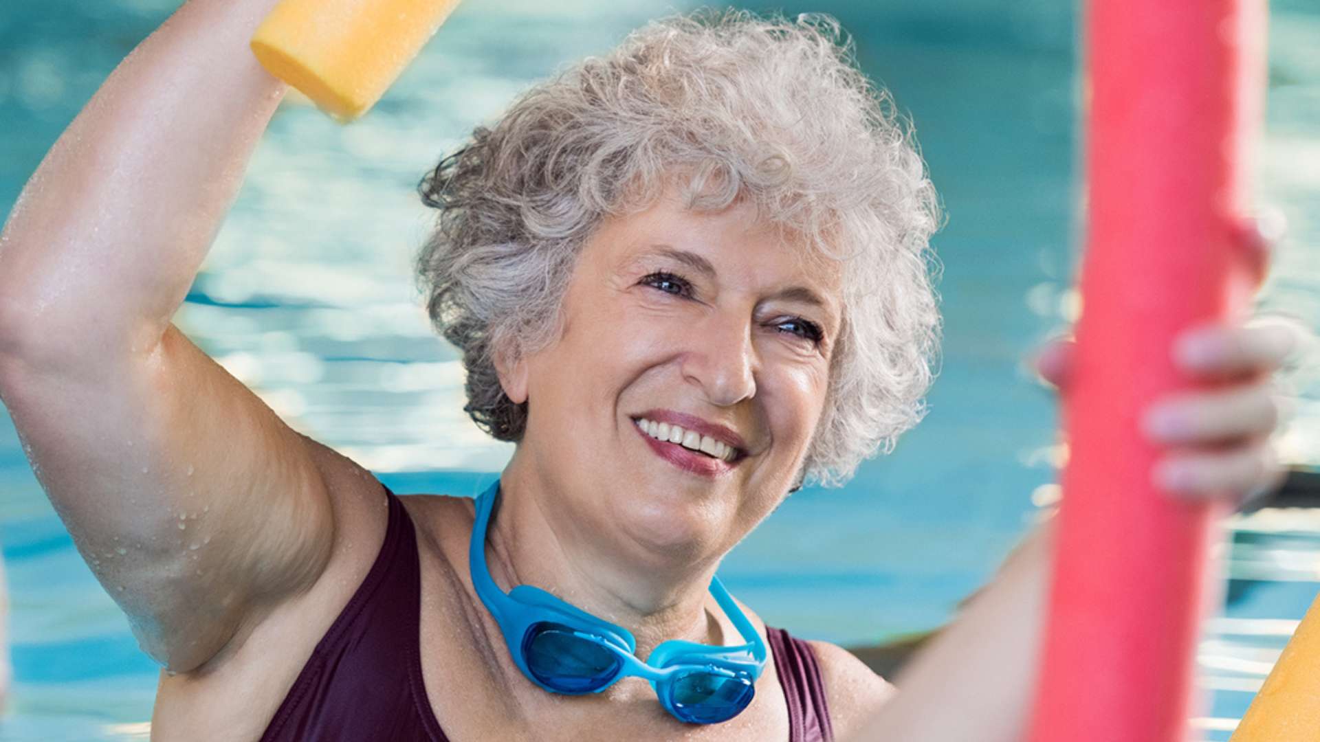 Woman enjoying an aqua fitness class at the YMCA Woman enjoying an aqua fitness class at the YMCA