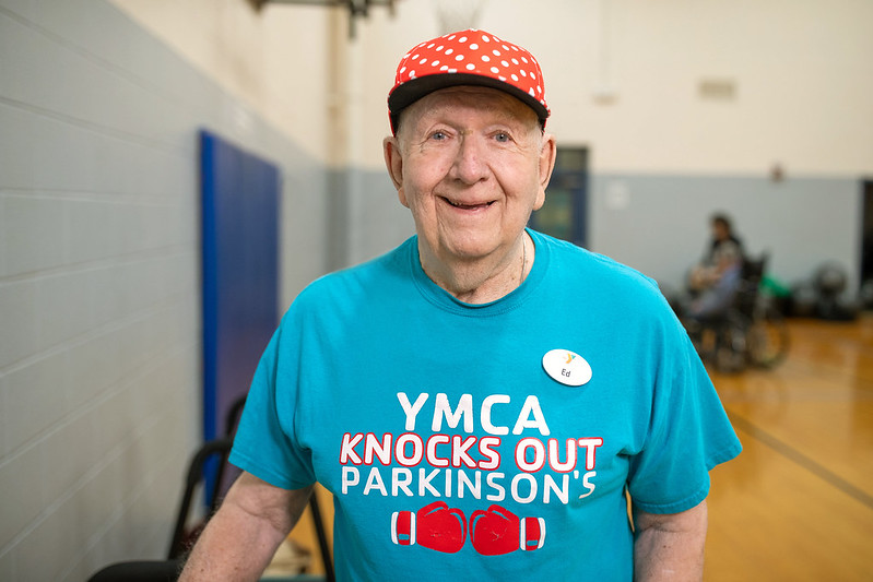 Man wearing Y shirt that says YMCA Knocks Out Parkinson's Man wearing Y shirt that says YMCA Knocks Out Parkinson's