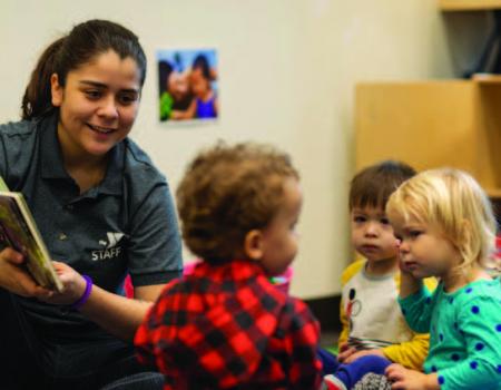 YMCA staff reading to children during child care program YMCA staff reading to children during child care program
