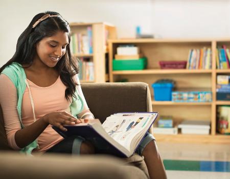 Teen reading book at YMCA programs for black youth Teen reading book at YMCA programs for black youth