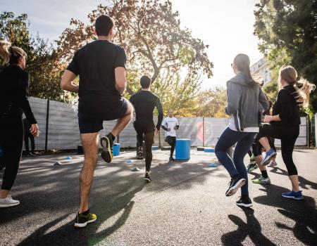 Adults jogging in place in group cardio class Adults jogging in place in group cardio class