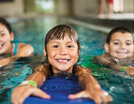 Children swimming at YMCA Louisville swimming pool Children swimming at YMCA Louisville swimming pool