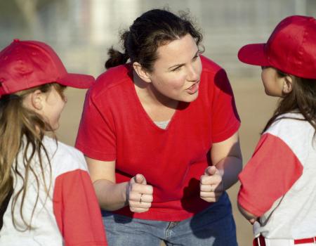 Coaching talking to kids during youth baseball league game Coaching talking to kids during youth baseball league game