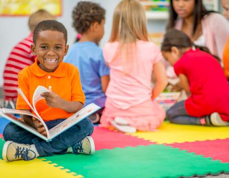 Child reading book at YMCA child development center Child reading book at YMCA child development center