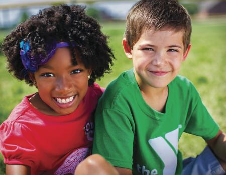 Smiling girl and boy sitting outdoors Smiling girl and boy sitting outdoors