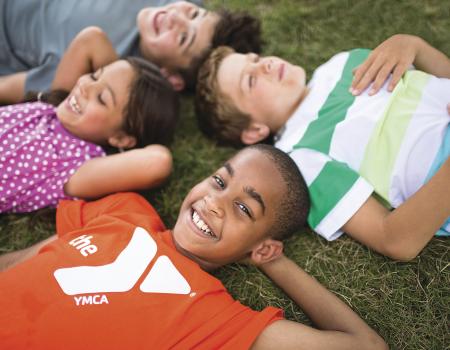 Group of kids laying on the ground looking at clouds Group of kids laying on the ground looking at clouds