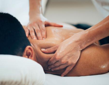 Man on massage table receiving shoulder massage Man on massage table receiving shoulder massage