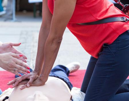 Instructor leading student in CPR training course Instructor leading student in CPR training course
