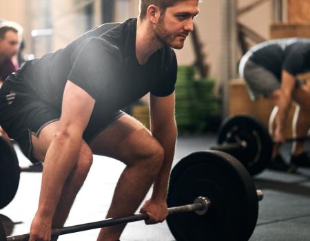 Group of men deadlifting Group of men deadlifting