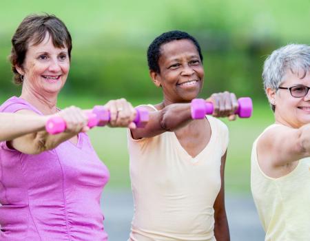 Group of women lifting hand weights together Group of women lifting hand weights together