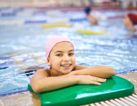 Girl on the side of a swimming pool Girl on the side of a swimming pool