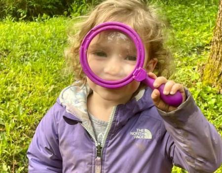 Girl holding a magnifying glass Girl holding a magnifying glass