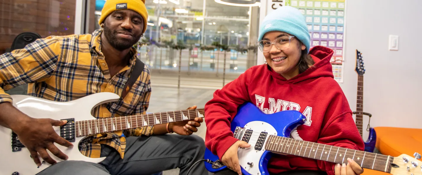 Two people playing guitars