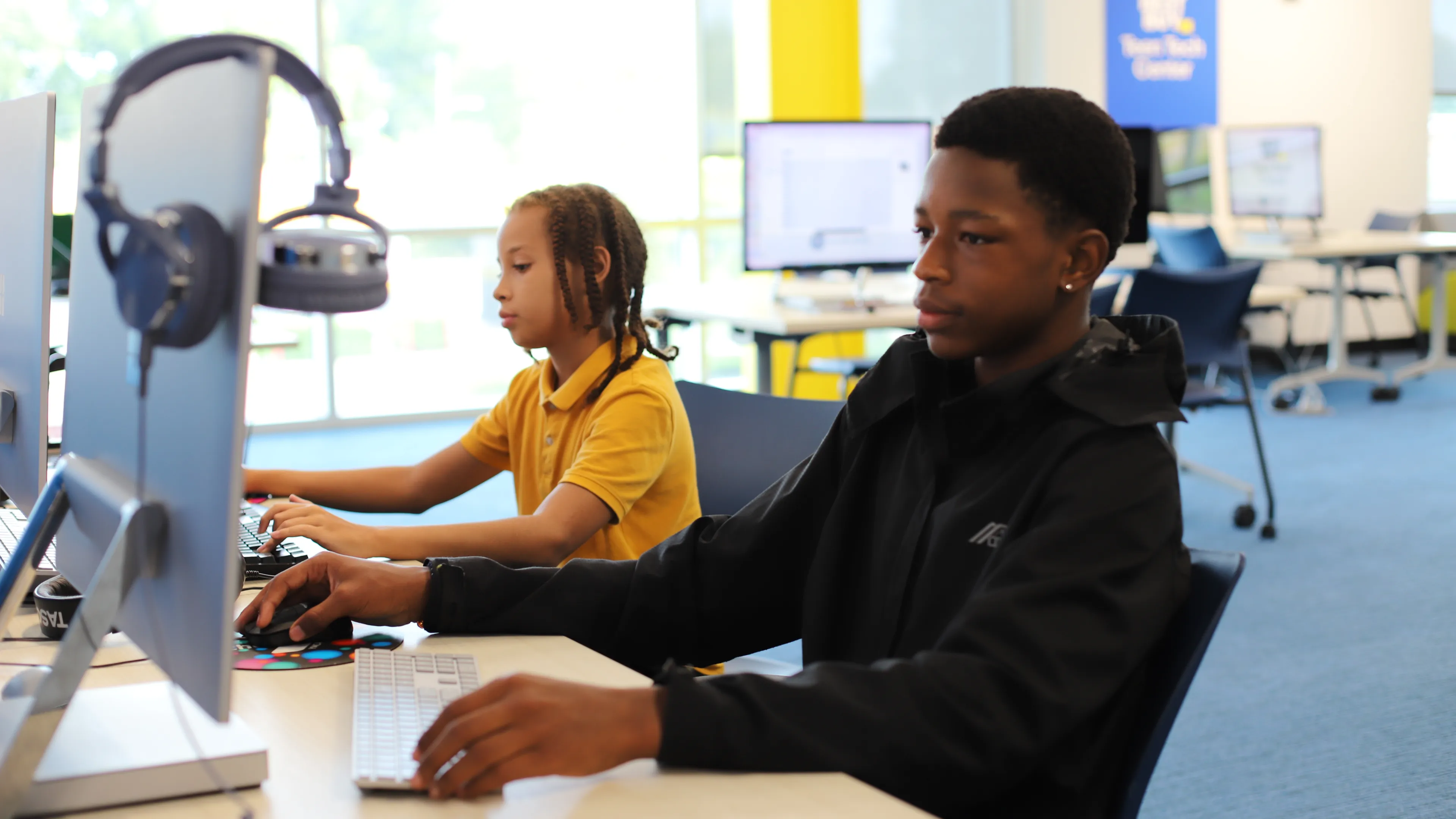 Teens looking at computer screens